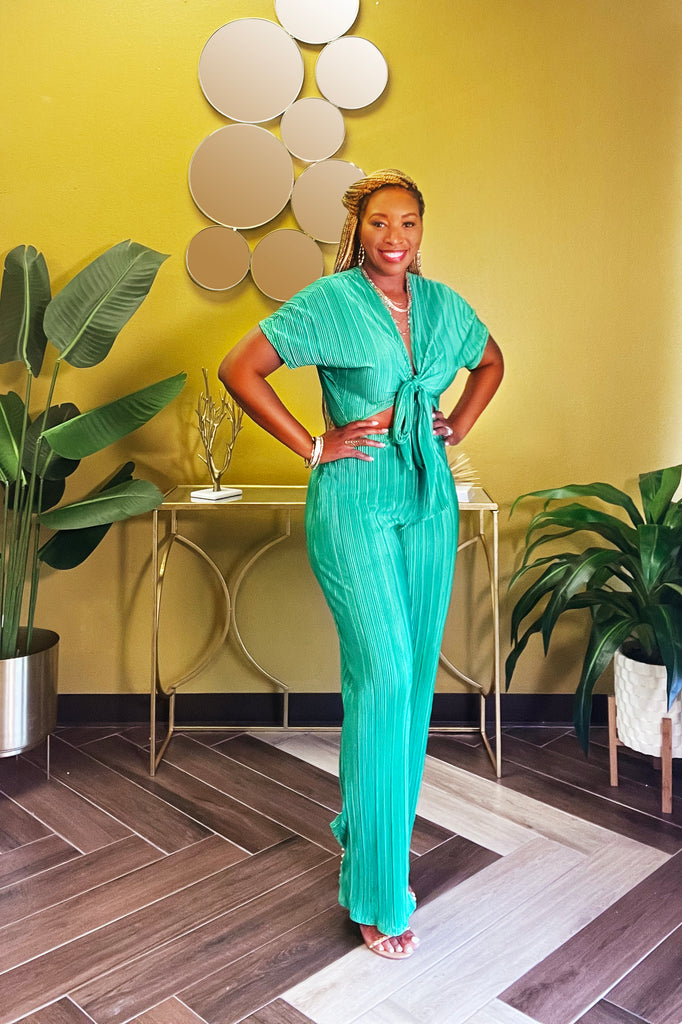 Emerald green two-piece set with short sleeve crop top and self-tie front, paired with high-waisted wide-leg pants featuring an elastic waistband. Stylish with great stretch and comfort.