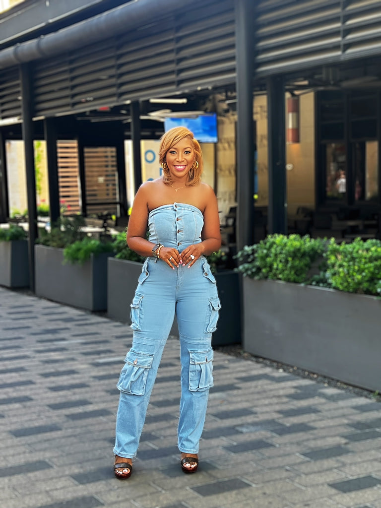 Strapless denim cargo jumpsuit with front pockets, button-up closure, and ultra-stretch fabric for a stylish, figure-hugging fit.
