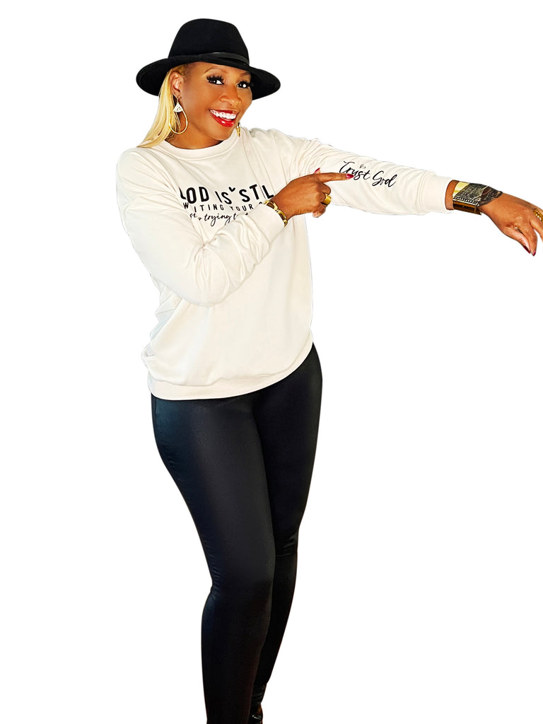 Lightweight sweater top featuring an uplifting 'In Him We Trust' message – a cozy blend of comfort and faith-filled style for everyday inspiration.