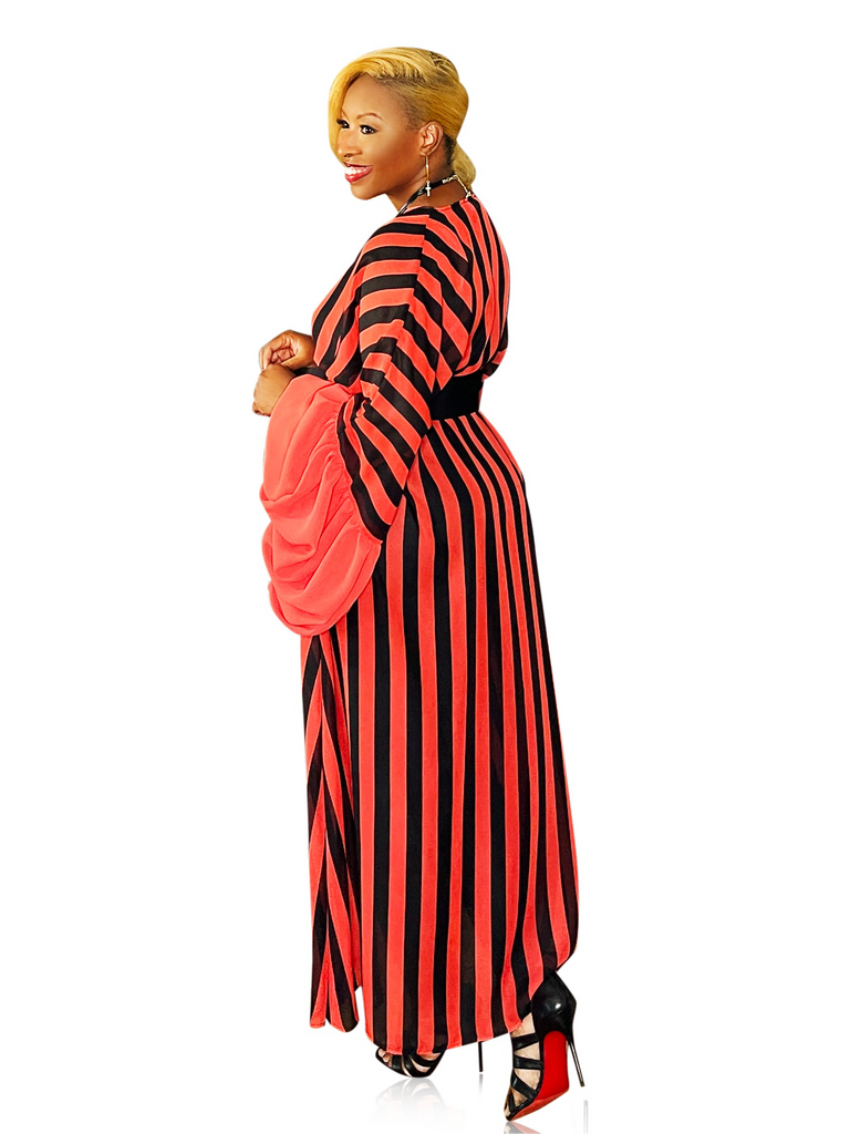 Red and black long duster kimono with exaggerated sleeves, open front, and side pockets, featuring a full, flowing fit for a dramatic and elevated look.