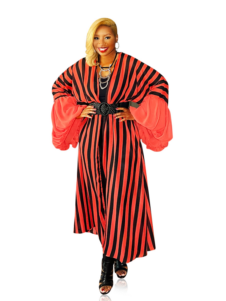 Red and black long duster kimono with exaggerated sleeves, open front, and side pockets, featuring a full, flowing fit for a dramatic and elevated look.