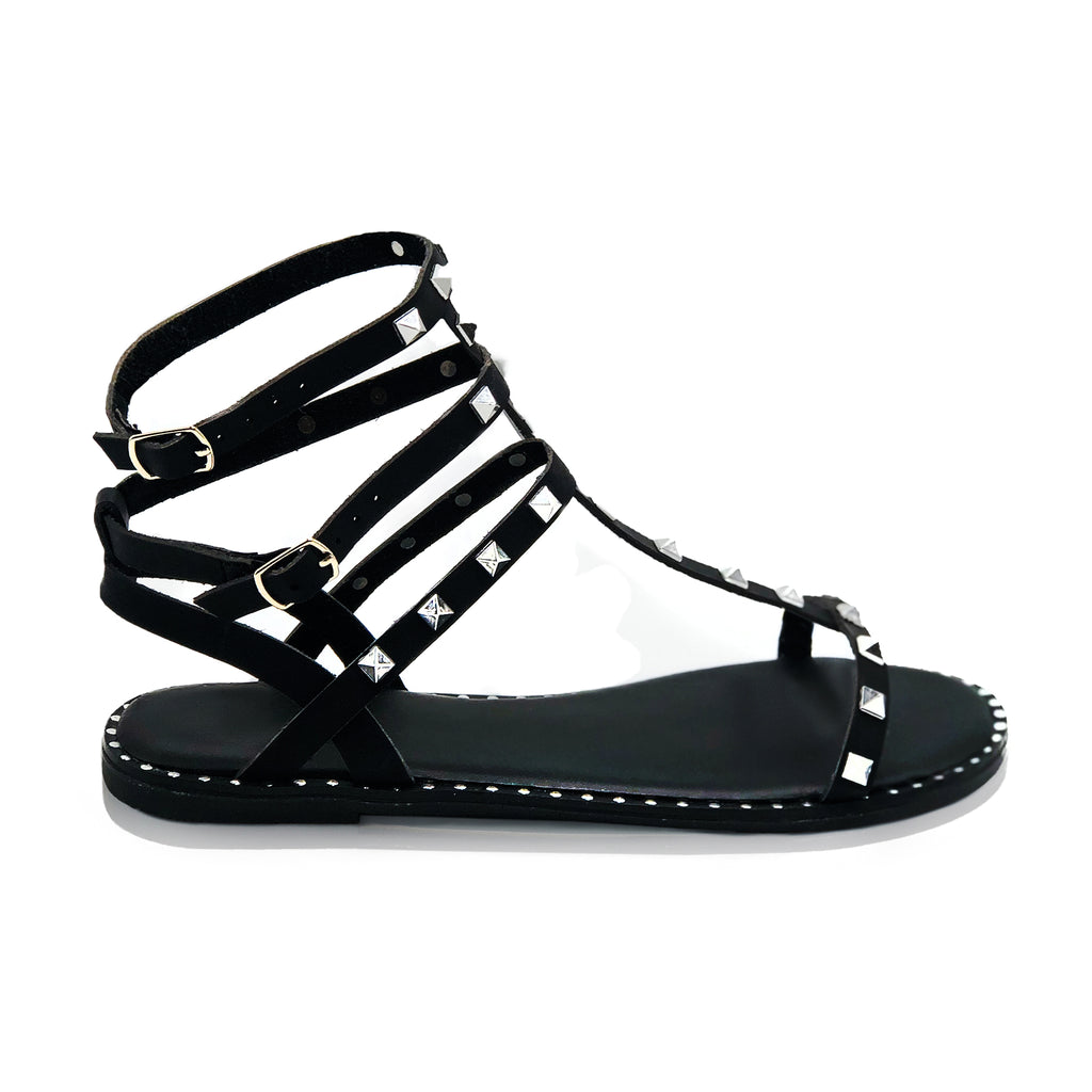 Gladiator sandals in black studded with an ankle strap closure 