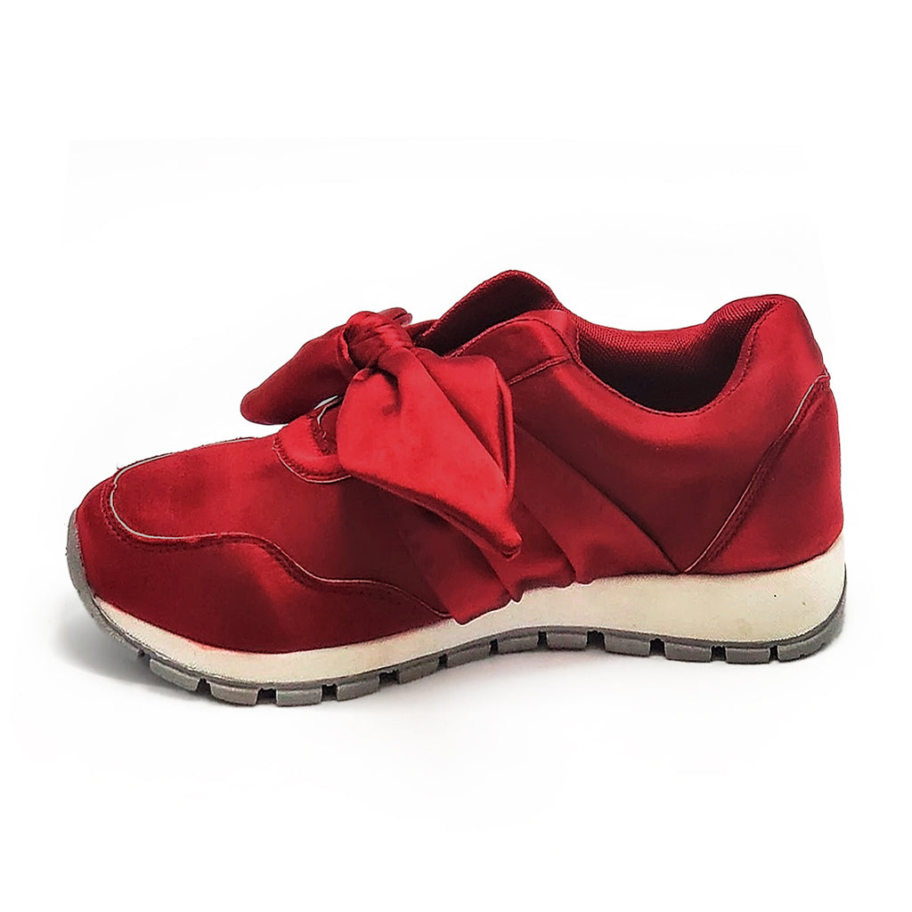 Burgundy slip-on sneakers with an oversized front bow add a fun touch to this look.