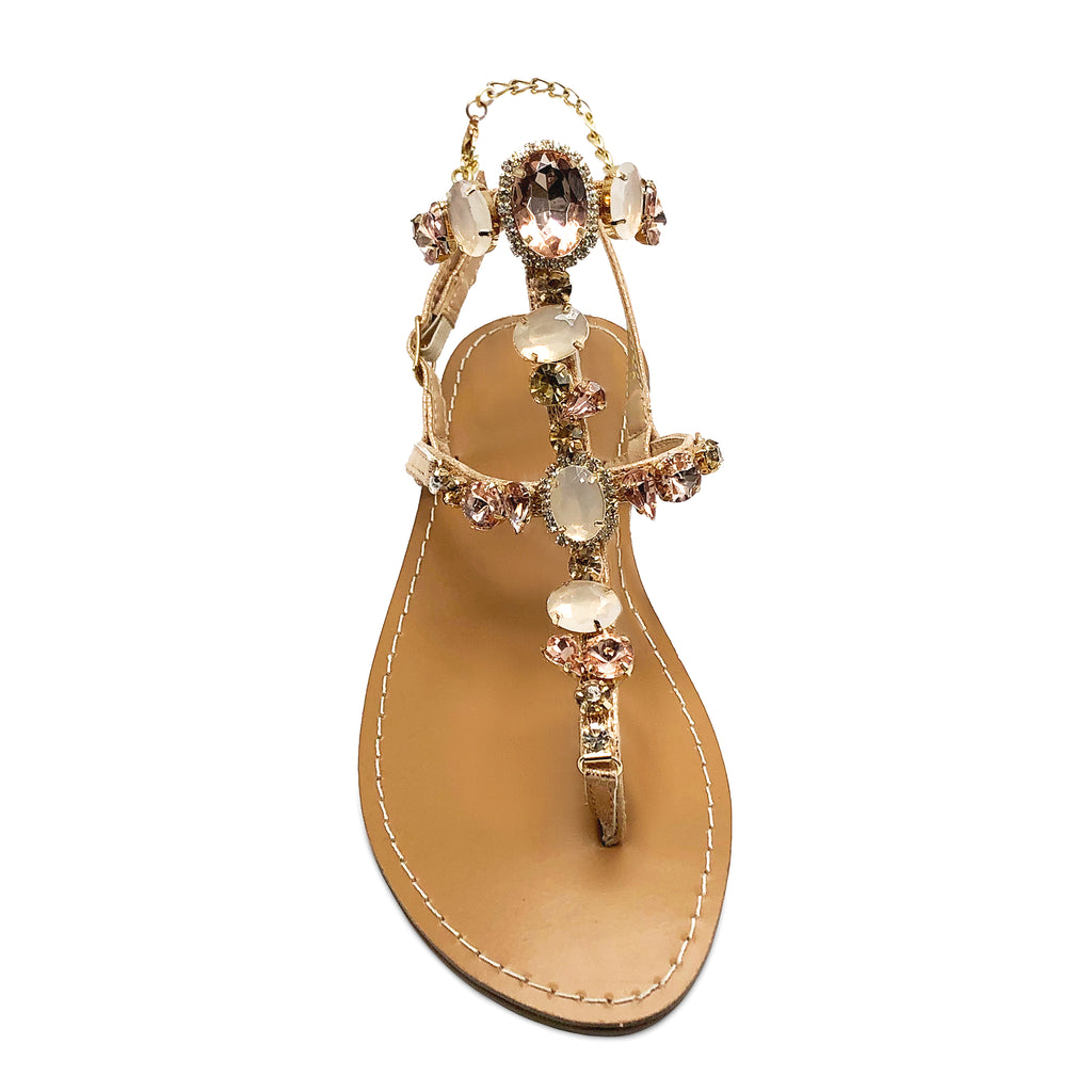 Champagne colored leather trim eloquently adorned with bedazzled jewels that accent the outer trim of the sandal.