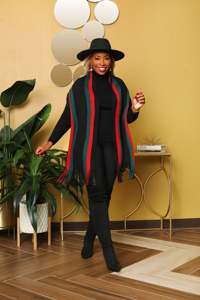 Get wrapped up in style and comfort with this black, red and green scarf. Style this cutie multiple ways. 